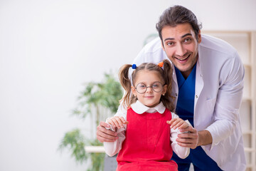 Fototapeta premium Small girl visiting young male doctor oculist