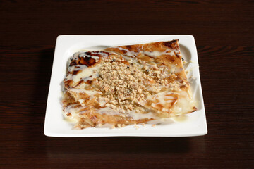 Traditional Turkish dessert sweetness sprinkled with nuts and condensed milk. Photos for restaurant and cafe menus