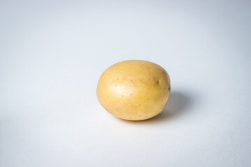 Fototapeta premium One potato on a white background. New potatoes. Harvesting. Agriculture