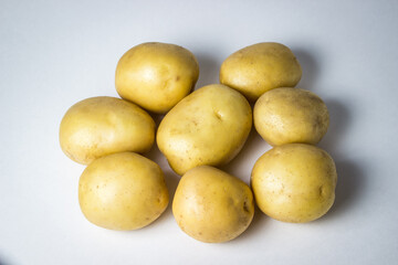 A bunch of potatoes on a white background. New potatoes. Harvesting. Agriculture