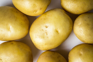 A bunch of potatoes on a white background. New potatoes. Harvesting. Agriculture