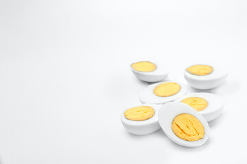 Obraz na płótnie Canvas Halves of boiled chicken eggs on white background