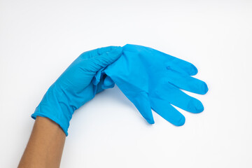 Female hand wears a protective glove for cleaning or tidying. Woman's hand latex glove gesture isolated on white. Female hand putting on latex glove isolated on white background