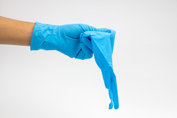 Female hand wears a protective glove for cleaning or tidying. Woman's hand latex glove gesture isolated on white. Female hand putting on latex glove isolated on white background