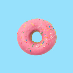 Donut in pink glaze with colored sprinkles on a blue background, top view