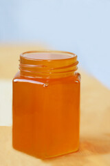 A jar filled to the top with honey . Sweet food. Close-up view. Natural food. Healthy diet.
