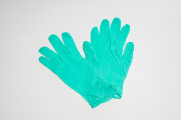 Fototapeta premium green rubber glove isolated on white background