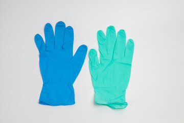 Fototapeta premium Blue rubber and green rubber glove isolated on white background