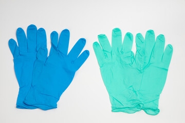 Fototapeta premium Blue rubber and green rubber glove isolated on white background