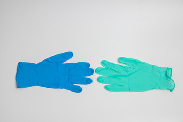 Blue rubber and green rubber glove isolated on white background