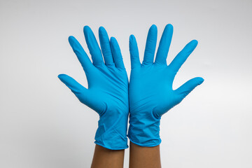 Woman hand wearing a blue rubber medical glove on white isolated background.