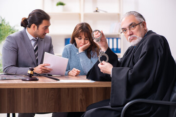 Young woman in courthouse with judge and lawyer