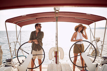 Young couple driving a yacht