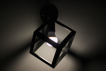 glowing lamp on the wall on a dark background