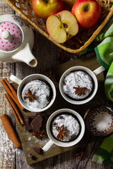 Quick autumn dessert. Autumn apple pie mugcake with red apples and spices on a rustic background. Top view flat lay background.