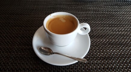 Cup of black aromatic coffee prepared for the first breakfast for a good mood