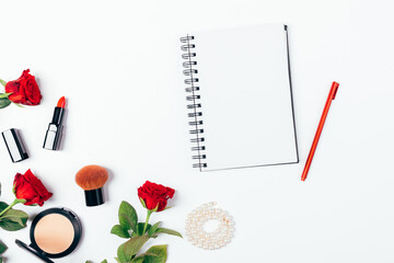 Obraz na płótnie Canvas Blank notebook with pen next to makeup products