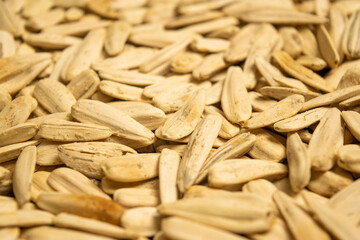 White sunflower seeds roasted with sea salt the texture of the surface. Close up.