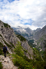 Fototapeta na wymiar male backpacker is hiking. Waxenstein mountain peaks, Flanks of the Zugspitze, Wetterstein Mountains. circular hike over the hupfleitenjoch Kreuzjoch, Wettersteingebirge Bavaria Germany
