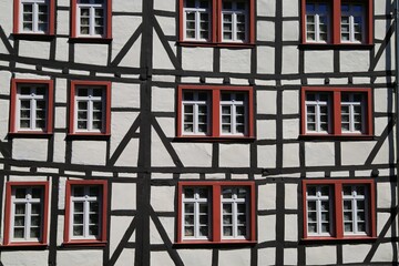 View on isolated skew facade of timber frame monument house with windows - Monschau, Germany