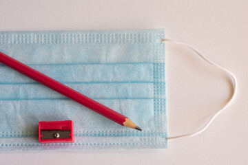 Pencil and mask, necessary objects on the way back to school