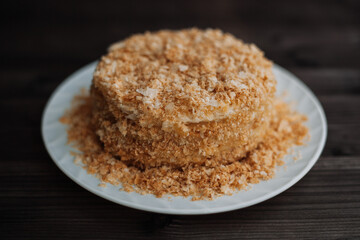 Fototapeta na wymiar homemade layer cake with crumb on a dark background