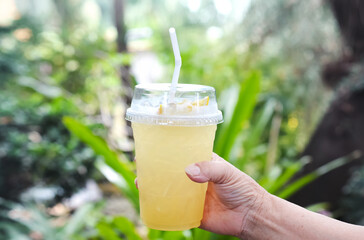 holding lemon juice, Summer lemonade and cooling beverage