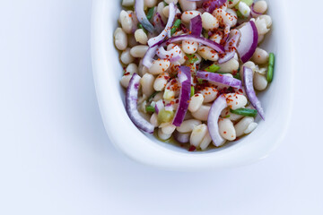 Traditional Turkish Bean,Piyaz Salad in white plate with copy space.