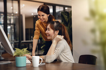 Teamwork, Working Together. Smiling Two Business Woman Workigng on Computer in Modern Office. Eyes...