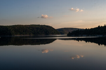 sunset over calm lake. mirroring clouds. Rappbodetalsperre, Harz, Germany
