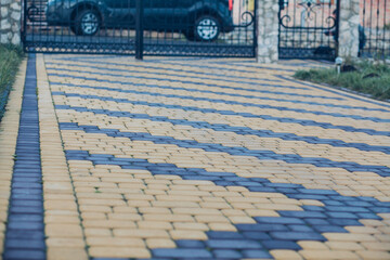 Nested pavers of various colors, around the grass is green, chic garden
