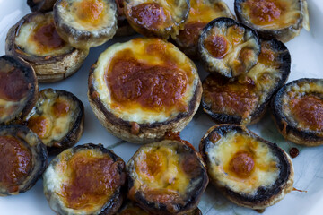 Baked with butter and cheddar mushrooms on bake paper,top view