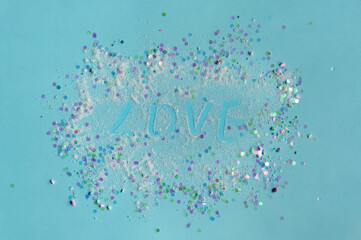 blue background in pastel colors, round sparkles and shiny sand are scattered in a circle