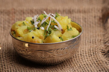 Aloo sabzi is a Indian main course dish which goes well with hot puris, chapatti, roti or dal. made with boiled potato 