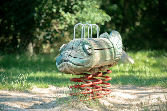 Wooden fish spring rocker in a playground