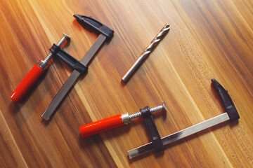 Two wood clamps on a wooden table.