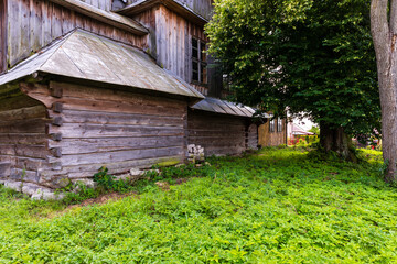 Part of wooden log dovetail architecture wall. Old church at countryside. Chotylub village, Poland, Europe.