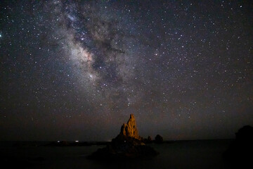 Naklejka na ściany i meble Long time exposure of the Milky Way at night in Arrecife de las Sirenas, in Cabo de Gata, Almeria, Spain