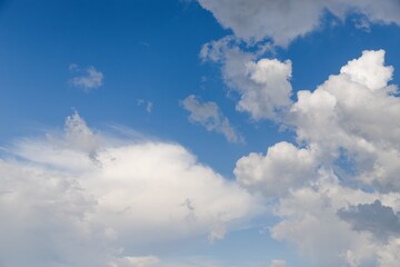 Naklejka na ściany i meble Light blue sky with fluffy white clouds
