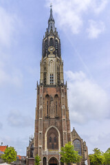 View of XV century Belfry of New Church (Nieuwe Kerk, 1396 - 1496) on central Market square in Delft, Holland. New Church, with 108,5 m church tower - second highest church in the Netherlands.