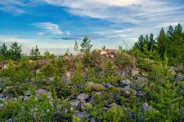 Majestic sunset in the mountains forest. Dramatic sky. Ural mountains.
