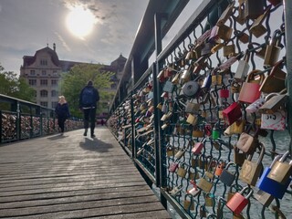 people walking on the Muhlesteg bridge, Love lock bridge over river Limmat, Zurich, Switzerland