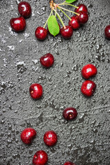 Naklejka na ściany i meble Fresh cherries on black background