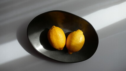 close up view of a bowl of fresh lemons