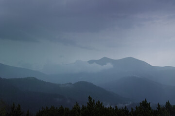Naklejka na ściany i meble Sunset in the cloudy mountains of the Carpathians