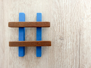 colorful wooden hashtag on wooden background
