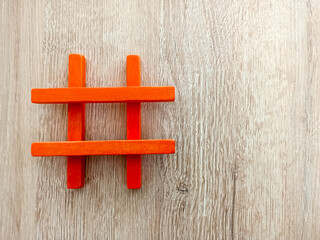 colorful wooden hashtag on wooden background