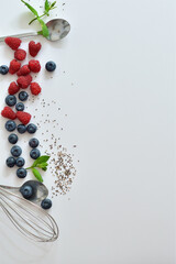 Summer layout made with juicy ripe berries of blueberries and raspberries on a white background. Summer mood.
