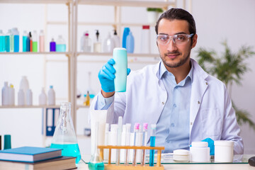 Young male chemist working in the lab