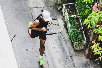 top view of running man in alleyway